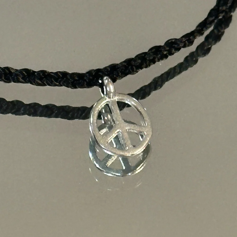 Pura Vida. Black Braided Bracelet with Silver Peace Charm and Red Accent